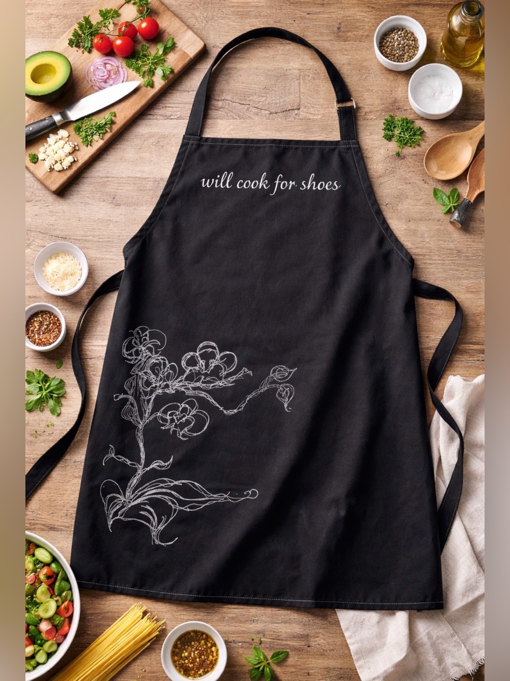 Black Apron with White Floral Sketch and 'will cook for shoes' Script